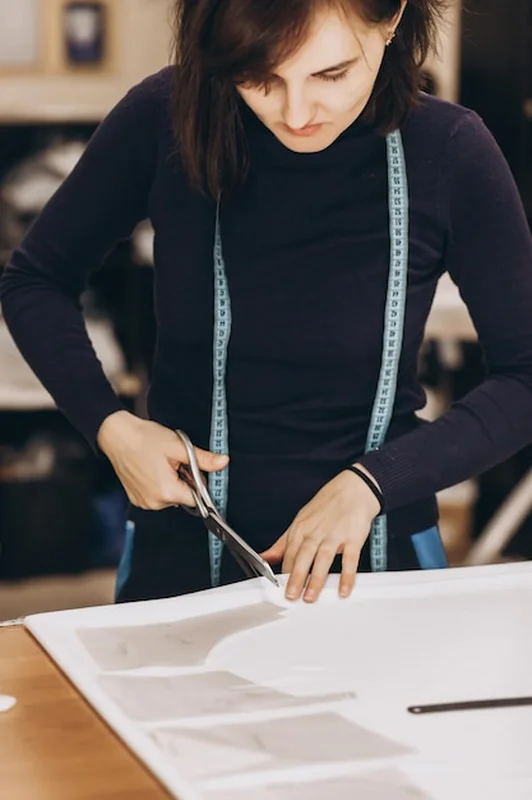 Krawiec wycina tkaninę zgodnie ze wzorem