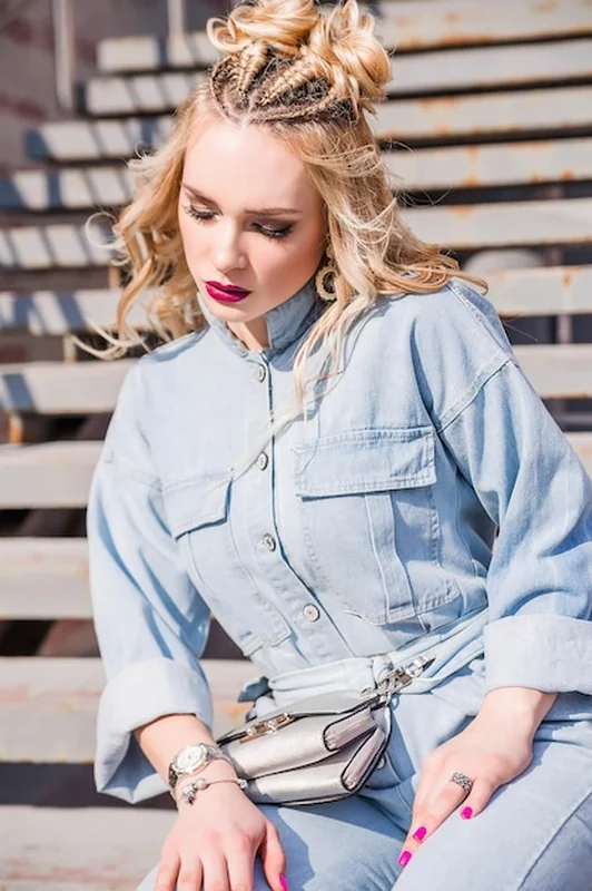 Blondynka w dżinsowym kombinezonie na schodach